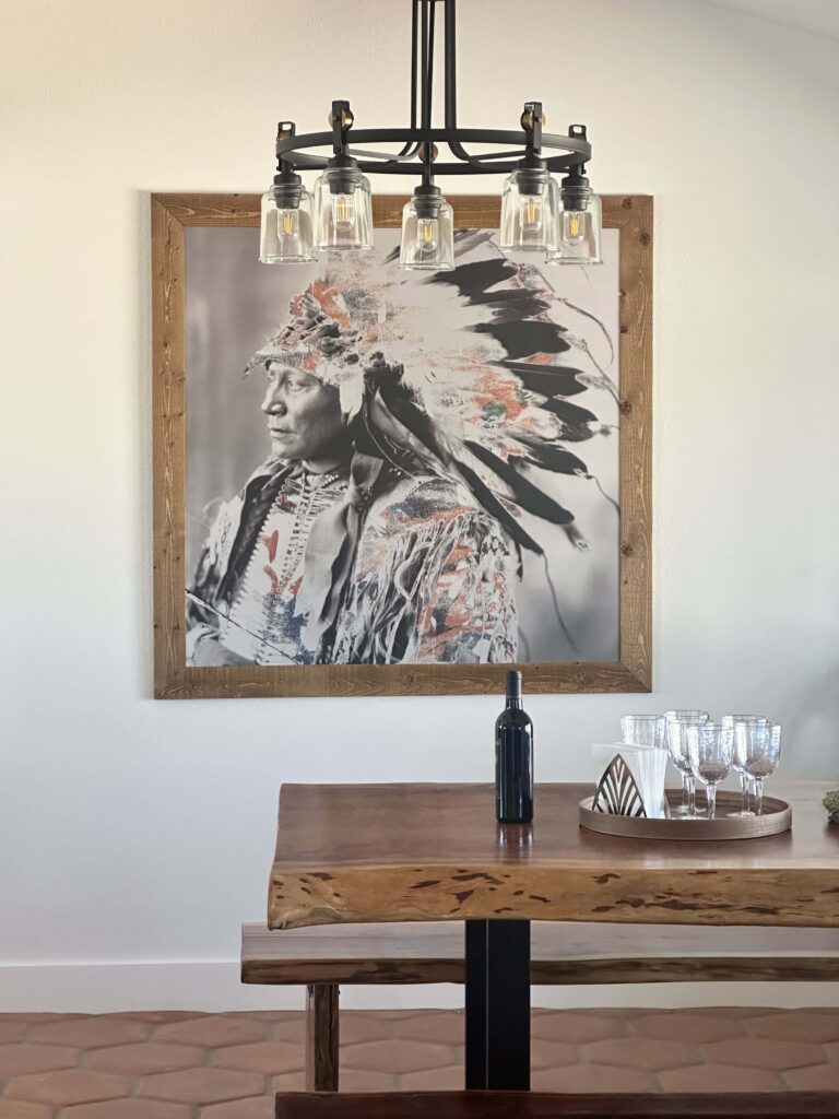 Dining nook with a live-edge wood table and framed wall art at The Desert Shadow